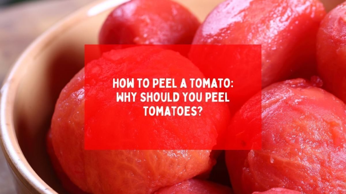 Tomato being peeled to remove its skin after blanching